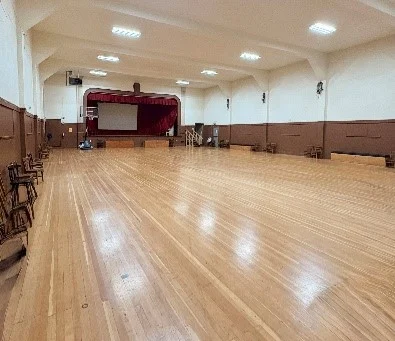Community Center gym with hardwood floor and stage