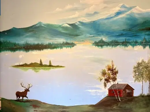 Painted mural of a mountain lake and elk inside the Athol Community Center