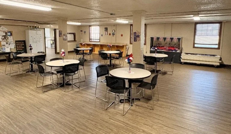 Main room of the Athol Community Center set with round tables and chairs